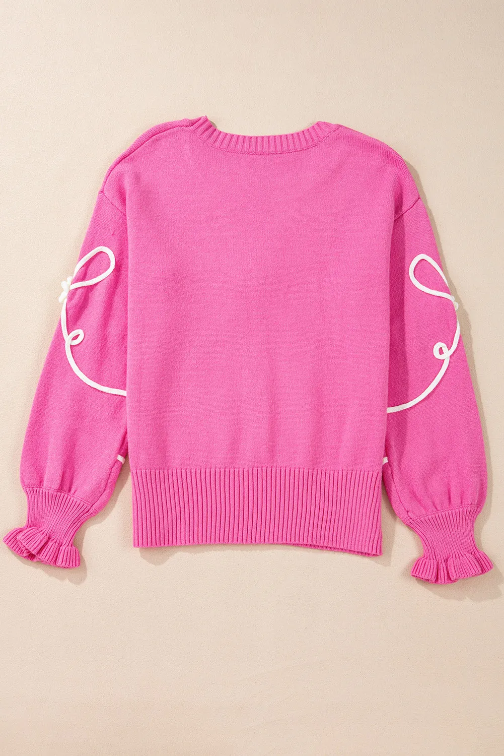 Pull décontracté à bordure ctelée avec nud fleuri et cordon rose vif